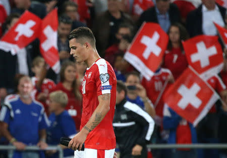 Football Soccer - Switzerland v Portugal - 2018 World Cup Qualifier - St. Jakob-Park, Basel, Switzerland - 6/9/16. Switzerland's Granit Xhaka walks out of the pitch after reveiving a red card. REUTERS/Ruben Sprich