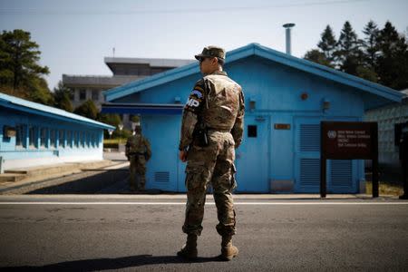 U.S. army soldiers stand guard at the truce village of Panmunjom inside the demilitarized zone (DMZ) separating the two Koreas, South Korea, April 18, 2018. Picture taken on April 18, 2018. REUTERS/Kim Hong-Ji/Files