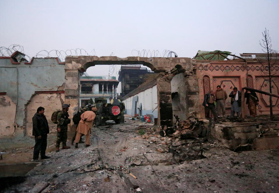 <p>Afghan officials inspect the entrance gate of Save the Children Aid group in Afghanistan, after a blast and gun fire in Jalalabad, Afghanistan, Jan. 24, 2018. (Photo: Parwiz/Reuters) </p>