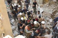 A survivor is taken out of the rubble after a massive explosion in Beirut, Lebanon, Wednesday, Aug. 5, 2020. (AP Photo/Hassan Ammar)