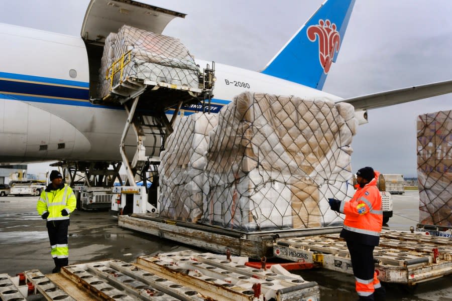 FILE – Ground crew at the Los Angeles International airport unload pallets of supplies of medical personal protective equipment, PPE, from a China Southern Cargo plane upon arrival on Friday, April 10, 2020. Some states that stockpiled millions of masks and other personal protective equipment during the coronavirus pandemic are now throwing the items away. (AP Photo/Richard Vogel, File)