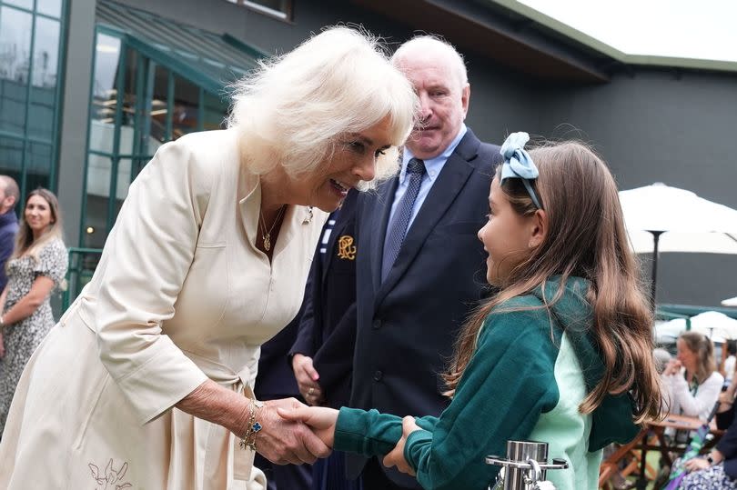 Camilla speaks with Camila, daughter of Mexican tennis player Santiago Gonzalez