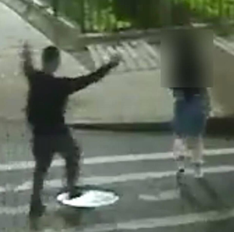 Surveillance image shows a man approaching a woman at a crosswalk before Brooklyn kidnapping (NYPD)