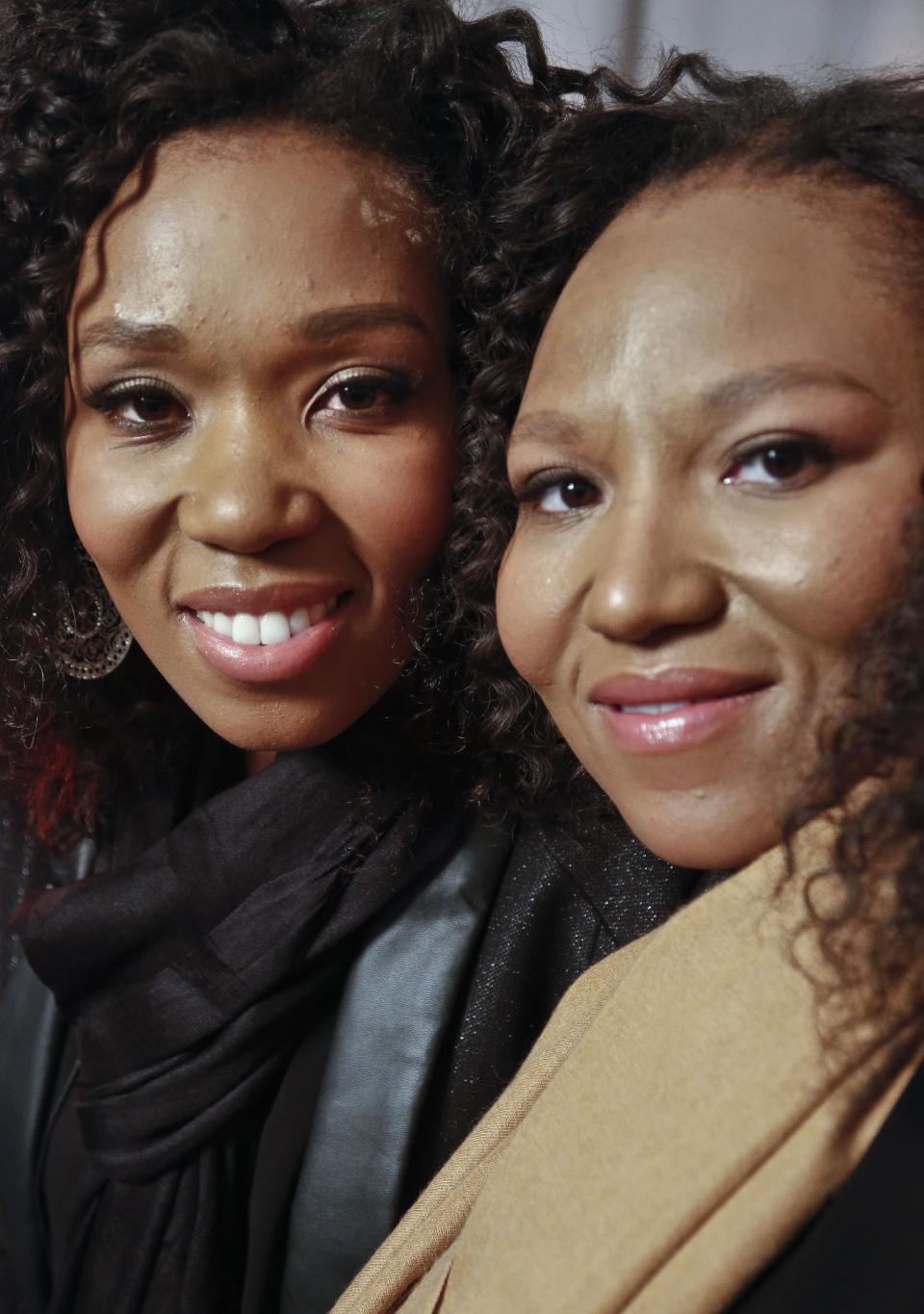 In this Wednesday, Feb. 6, 2013 photo, Swati Dlamini, left, and Zaziwe Dlamini-Manaway, granddaughters of Nelson and Winnie Mandela, pose during an interview in New York. The sisters are stars of the new reality show "Being Mandela," produced by COZI TV for NBC. The 30-minute weekly show premieres on Sunday, Feb. 10 at 9 PM ET and will follow the next generation of Mandela family through the experiences of sisters Zaziwe and Swati and their families. (AP Photo/Bebeto Matthews)