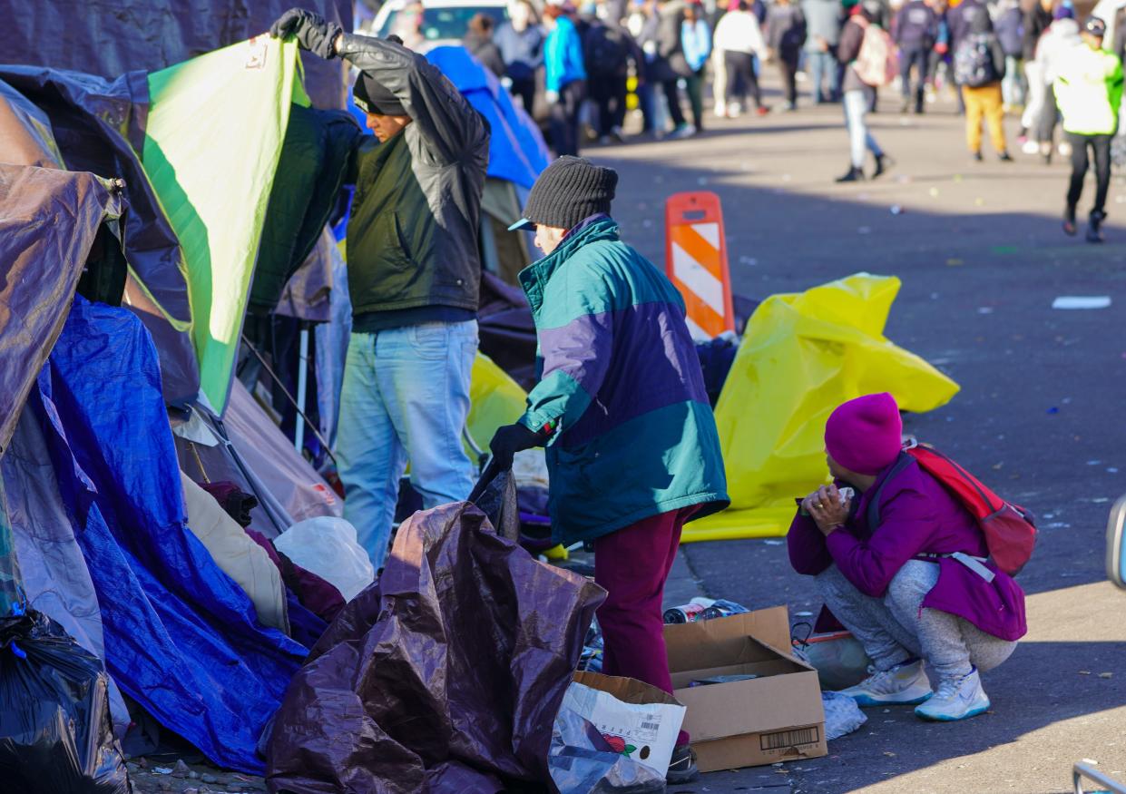 Migrants living in an illegal encampment in Denver clear out their belongings after city officials ordered the area cleared.