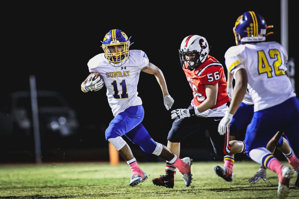 Damian Barragan (11) scurries around Gruver's Juan Angel Terrazas (56) during a District 3-2A Division II game Friday, Oct. 29, 2021 at Greyhound Stadium in Gruver, Texas.