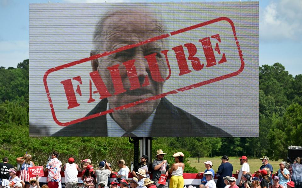 A poster of US President Joe Biden with the word "Failure" stamped across his face is displayed at a Trump rally in Virginia