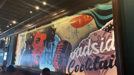 Nashville artist Stephen Sloan’s mural lives on the wall above wooden lofted tables at 5 Points Diner and Bar.