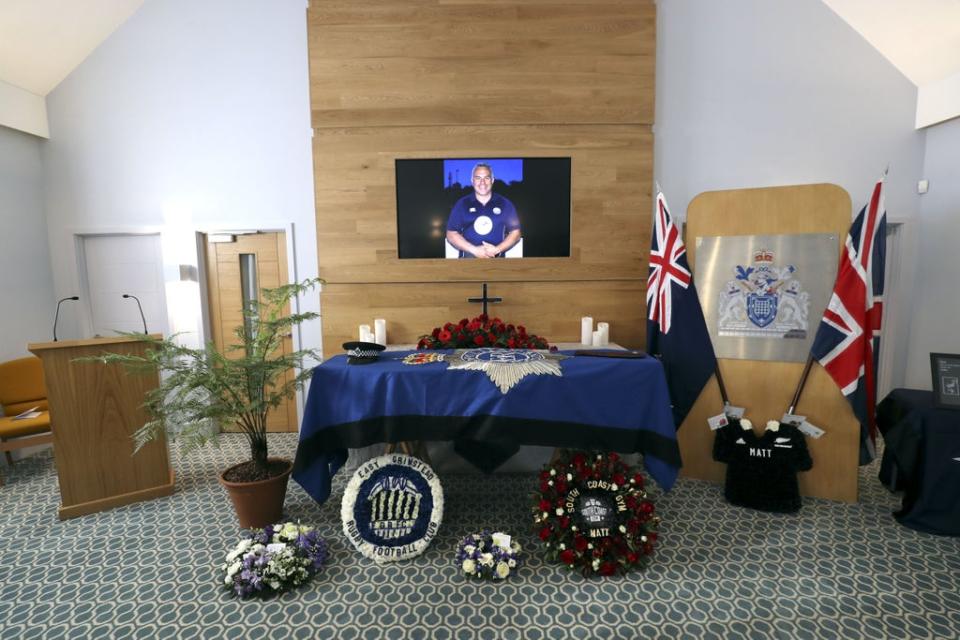 The coffin and floral tributes in the church before the funeral service of police officer Sergeant Matt Ratana (Gareth Fuller/PA) (PA Archive)