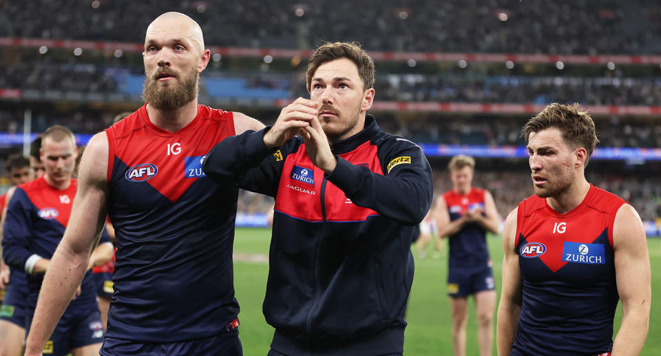 Seen here, Melbourne Demons players walk off shattered after their AFL semi-final defeat to Carlton.