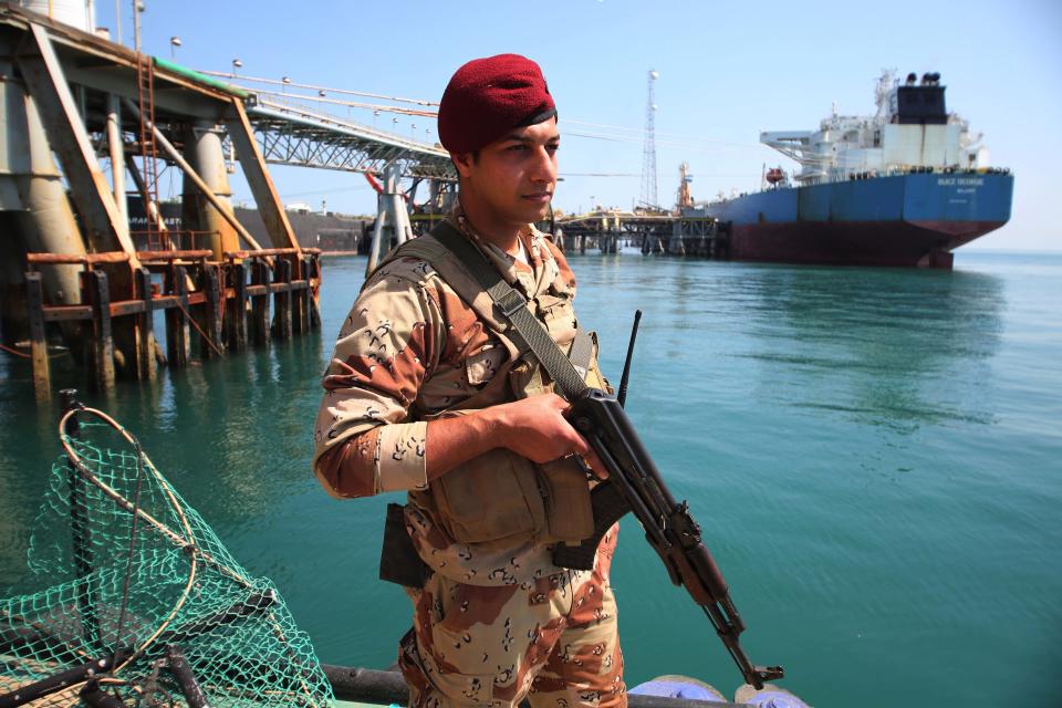 FILE -- In this Saturday, March 29, 2014 file photo, a member of the Iraqi navy stands guard while an oil tanker loads crude oil at Iraq's Al-Basra Offshore Terminal, Iraq. Oil Ministry spokesman Assem Jihad told The Associated Press that the government has stopped shipping the 10,000 to 12,000 barrels a day of oil it sells to Jordan at preferential rates because the only route for sending it --by truck down the Baghdad-Amman highway -- has become too dangerous. Jihad also said insurgent attacks against the main oil pipeline that sends oil to international market through Turkey’s Mediterranean port of Ceyhan have left it idle since March. (AP Photo/Nabil al-Jurani, File)
