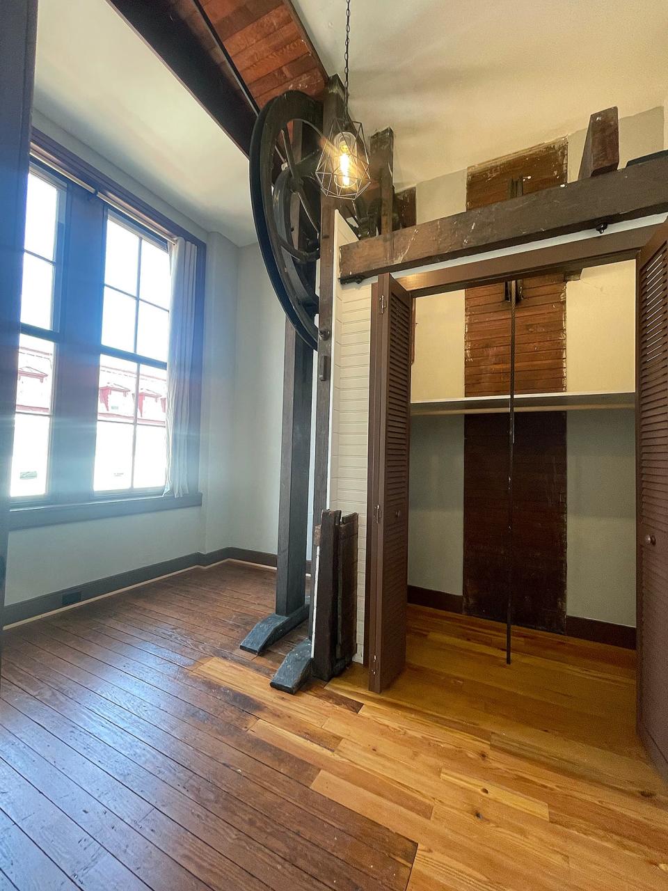 This Updegraff apartment features a small den or bedroom with a unique detail: the gear mechanism from the factory building's original elevator