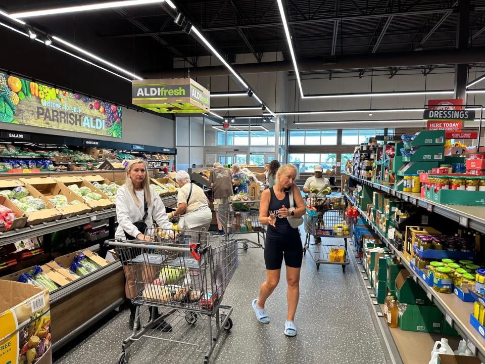 Customers at a Parrish Aldi Grocery store grab last minute produce and non-perishable food items Monday morning ahead of Hurricane Milton.