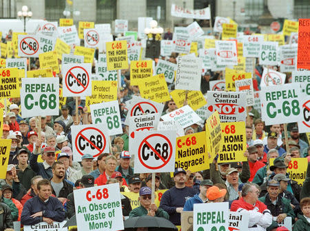 FILE PHOTO: About 9,000 gun-owners, upset about the Liberals' attempt to create a national registry of all gun owners and their arms, rally on Parliament Hill to protest the Federal Government's tough new gun law, C-68, in Ottawa, Ontario, Canada, September 22, 1998. REUTERS/Jim Young/File Photo