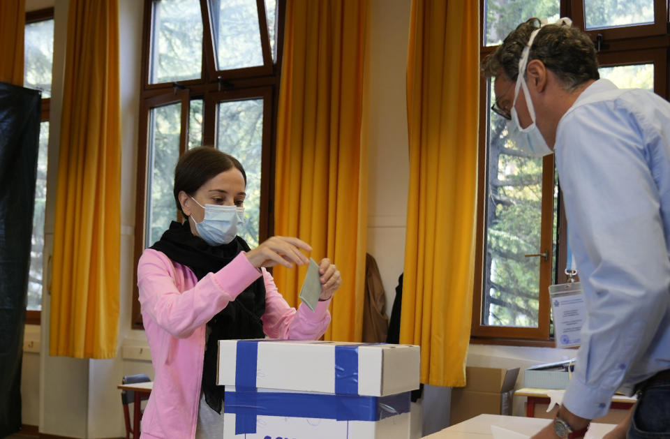 A woman casts her ballot for the abortion referendum at a polling station in San Marino, Sunday, Sept. 26, 2021. Tiny San Marino is one of the last countries in Europe which forbids abortion in any circumstance — a ban that dates from 1865. Its citizens are voting Sunday in a referendum calling for abortion to be made legal in the first 12 weeks of pregnancy. (AP Photo/Antonio Calanni)