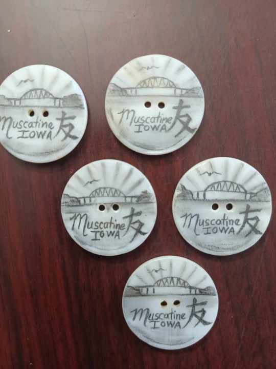 Pearl buttons decorated by Chris Anderson, including the Chinese symbol for “friend.”