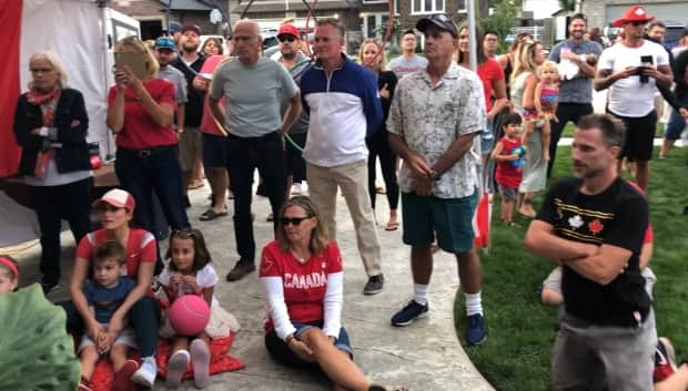 Noelle Montcalm's friends and family watch as Montcalm races the 400 metre hurdles in Tokyo (Jacob Barker/CBC - image credit)