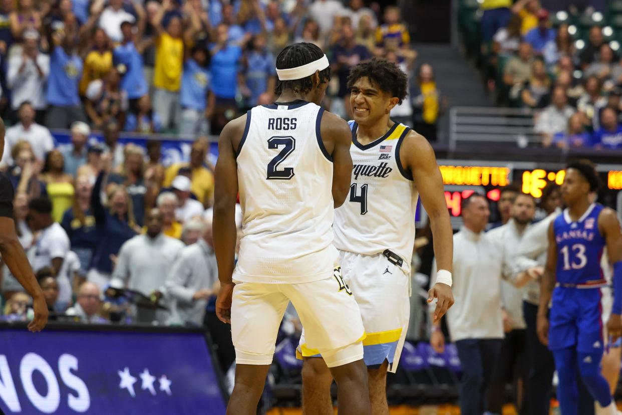 Chase Ross (2) of the Marquette Golden Eagles is congratulated by Stevie Mitchell (4) after draining a three-point shot during the second half of their 73-59 win over the Kansas Jayhawks in the semifinals of the Maui Invitational on Tuesday in Honolulu, Hawaii.