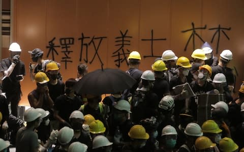 Hundreds of protesters poured into the building after hours of trying to break through windows - Credit: Vivek Prakash/AFP