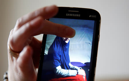 Alema Dolamic shows a picture of her sister who went to Syria, in Bedaci village, near Tesanj, Bosnia and Herzegovina, March 5, 2019. REUTERS/Dado Ruvic