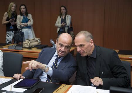 Greek Finance Minister Yanis Varoufakis (R) talks with Spanish Economy Minister Luis de Guindos during a Eurozone finance ministers emergency meeting on the situation in Greece in Brussels, Belgium June 27, 2015. REUTERS/Yves Herman