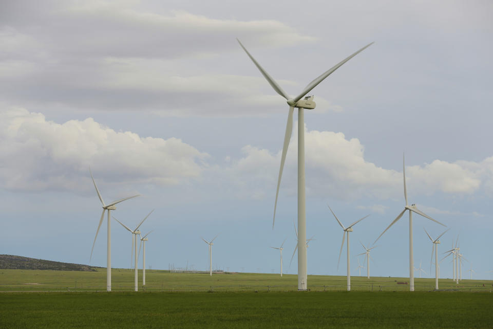 Wind turbines stand at a wind farm along the Montana-Wyoming state line on Monday, June 13, 2022. The rush to build wind farms to combat climate change is colliding with preservation of one of the U.S. West's most spectacular predators, the golden eagle. Scientists say the species is teetering on the edge of decline and worry that proliferating wind turbines could push them over the brink. (AP Photo/Emma H. Tobin)