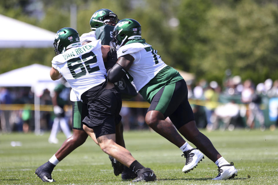 New York Jets offensive lineman Cameron Clark (72) attempts to block Greg Van Roten (62) and Morgan Moses (78) during practice at the team's NFL football training facility, Saturday, July. 31, 2021, in Florham Park, N.J. (AP Photo/Rich Schultz)