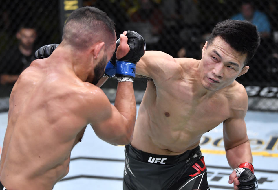 LAS VEGAS, NEVADA - JUNE 19: (R-L) 'The Korean Zombie' Chan Sung Jung of South Korea punches Dan Ige in a featherweight bout during the UFC Fight Night event at UFC APEX on June 19, 2021 in Las Vegas, Nevada. (Photo by Chris Unger/Zuffa LLC)