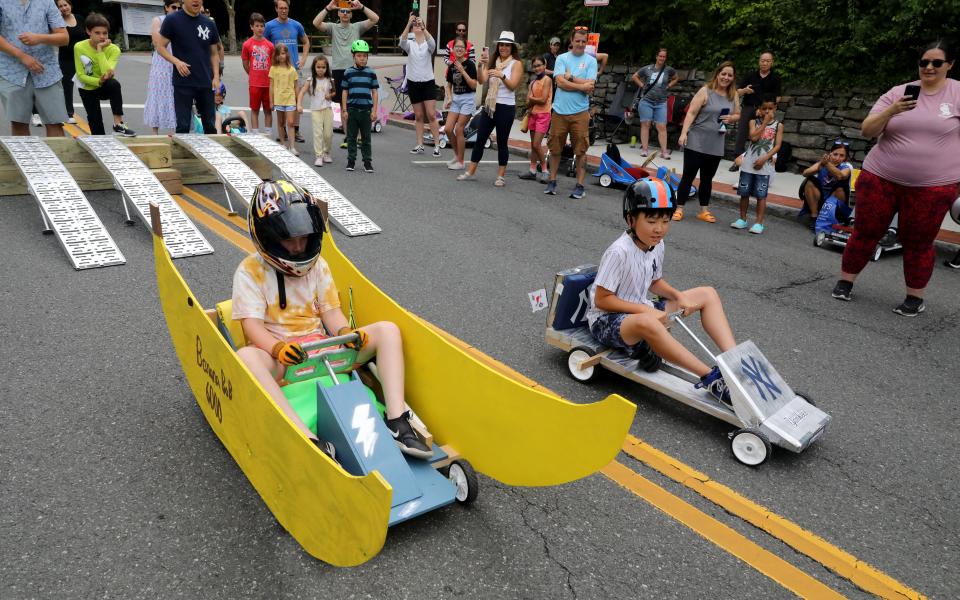 Hank Bell in the Banana Bob 6000 and Ian Hwangbo in the Miankee New York Yankees car, compete in the Soap Box Derby on Main Street in Dobbs Ferry, July 2, 2023. This event, not held in the village since 1973, was part of the 150th anniversary celebration over the 4th of July holiday weekend. Other activities included a trivia pub crawl, carnival at the waterfront, an ice cream party and celebrating the businesses in the downtown area. 