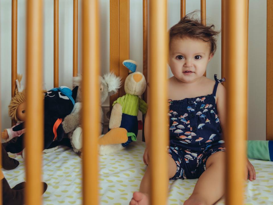 baby in gold crib