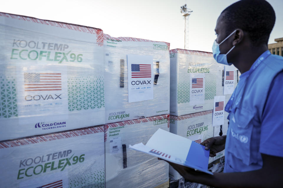 A UNICEF worker checks boxes of Moderna coronavirus vaccine after their arrival at the airport in Nairobi, Kenya Monday, Aug. 23, 2021. The first time that Moderna COVID-19 vaccines have been received in Kenya, 880,460 doses were delivered forming the first of two shipments totalling 1.76 million doses which were donated by the U.S. government via the COVAX facility, according to UNICEF who transported the vaccines. (AP Photo/Brian Inganga)