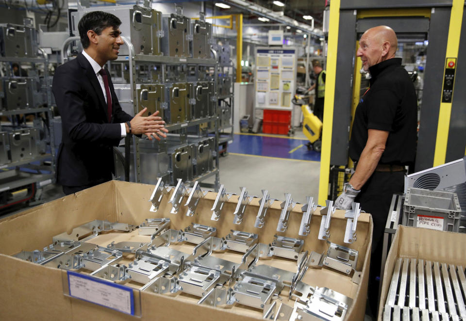 Britain's Chancellor of the Exchequer Rishi Sunak, left, speaks to employees during a visit to Worcester Bosch factory to promote the initiative, Plan for Jobs, in Worcester, England, Thursday July 9, 2020. (Phil Noble/Pool via AP)