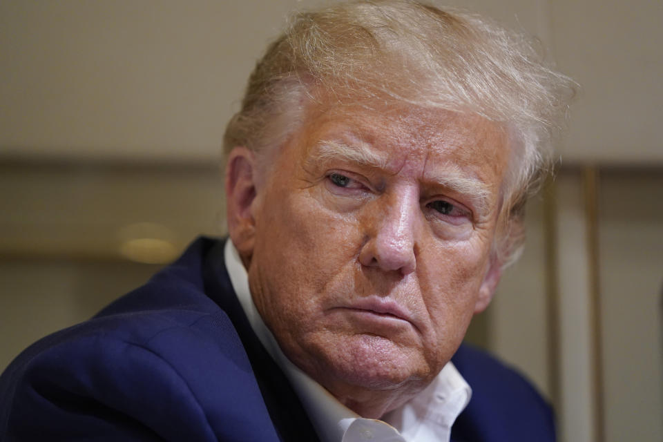 FILE - Former President Donald Trump listens as he speaks with reporters while in flight on his plane after a campaign rally at Waco Regional Airport, in Waco, Texas, Saturday, March 25, 2023, while en route to West Palm Beach, Fla. The outcome of past cases against defendants accused of hoarding classified documents loom as an ominous guidepost for the legal jeopardy Donald Trump could face. The former president pleaded not-guilty on Tuesday, June 13, to charges including willful retention of national defense information under the Espionage Act. (AP Photo/Evan Vucci, File)