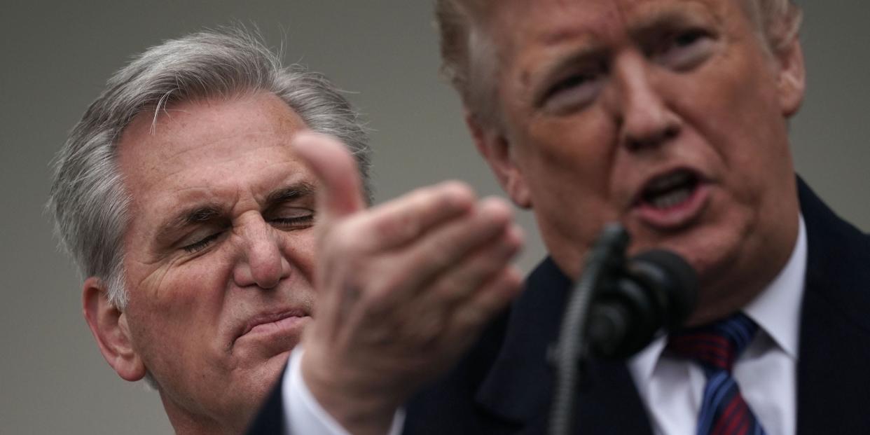 Kevin McCarthy flares his nose and furrows his brow behind Donald Trump.