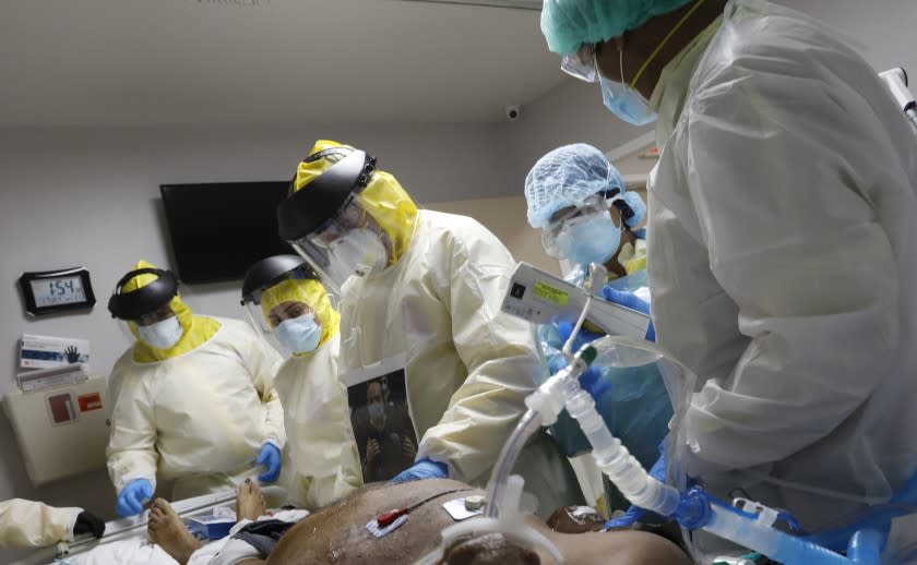 HOUSTON, TEXAS-JULY 1, 2020-HOUSTON, TEXAS-JULY 1, 2020-Putting a patient on a ventilator is a last resort. Dr. Joseph Varon, center, does emergency treatment on Terry Hill, age 65, after putting him on a ventilator assisted by his team of nurses and medical students. At United Memorial Medical Center in Houston, Texas, Dr. Joseph Varon leads a team to fight the increasing number of coronavirus patients in the expanded Covid-19 ward on July 1, 2020. (Carolyn Cole/Los Angeles Times)