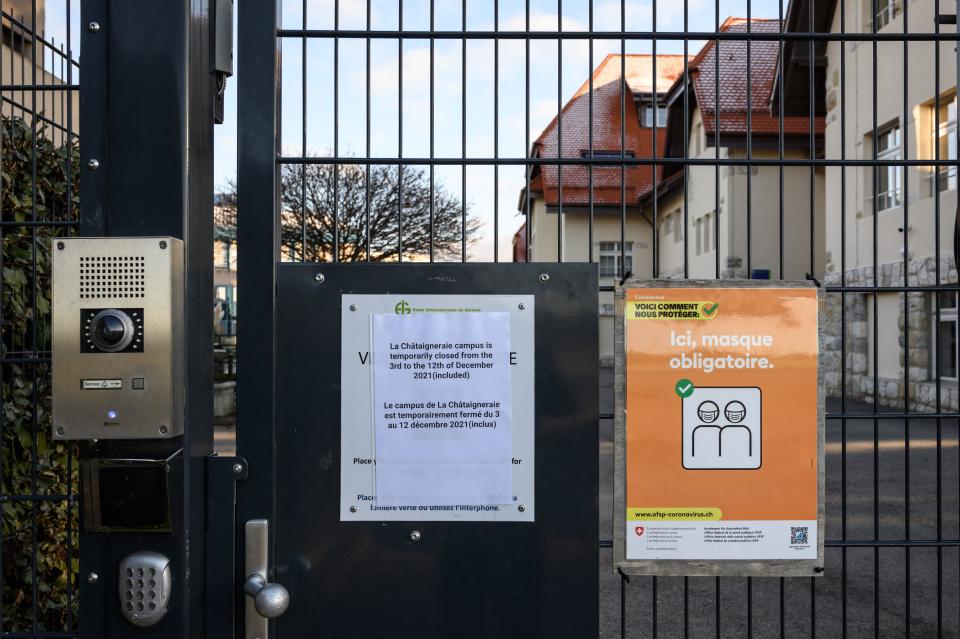 This photograph taken on December 3, 2021, shows placard at the entrance of the Châtaigneraie campus of the International School of Geneva, closed after two cases of the Omicron variant were found, in Founex, Switzerland. - At least 2,000 peoples, including 1,600 children, have been in quarantine after two cases of the Omicron variant were found on one of the campuses of the International School of Geneva. 
