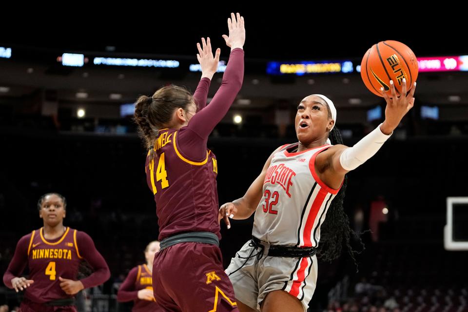 Feb 8, 2023; Columbus, OH, USA;  Ohio State Buckeyes forward Cotie McMahon (32) shoots around Minnesota Golden Gophers guard Isabelle Gradwell (14) during the first half of the NCAA women’s basketball game at Value City Arena. Mandatory Credit: Adam Cairns-The Columbus Dispatch