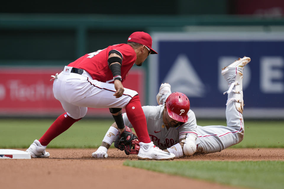 Washington Nationals shortstop Ildemaro Vargas, left, tags out Philadelphia Phillies' Nick Castellanos as Castellanos attempts to stretch his single to second base in the first inning of a baseball game, Sunday, June 4, 2023, in Washington. (AP Photo/Patrick Semansky)