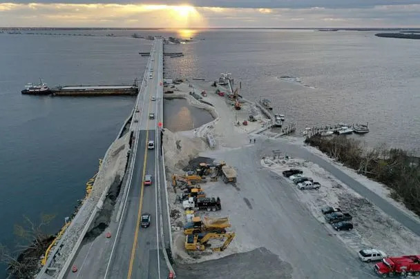 PHOTO: Vehicles drive over the temporarily repaired Sanibel Island causeway less than three weeks after Hurricane Ian destroyed it on October 20, 2022 in Arcadia, Florida. (Joe Raedle/Getty Images)