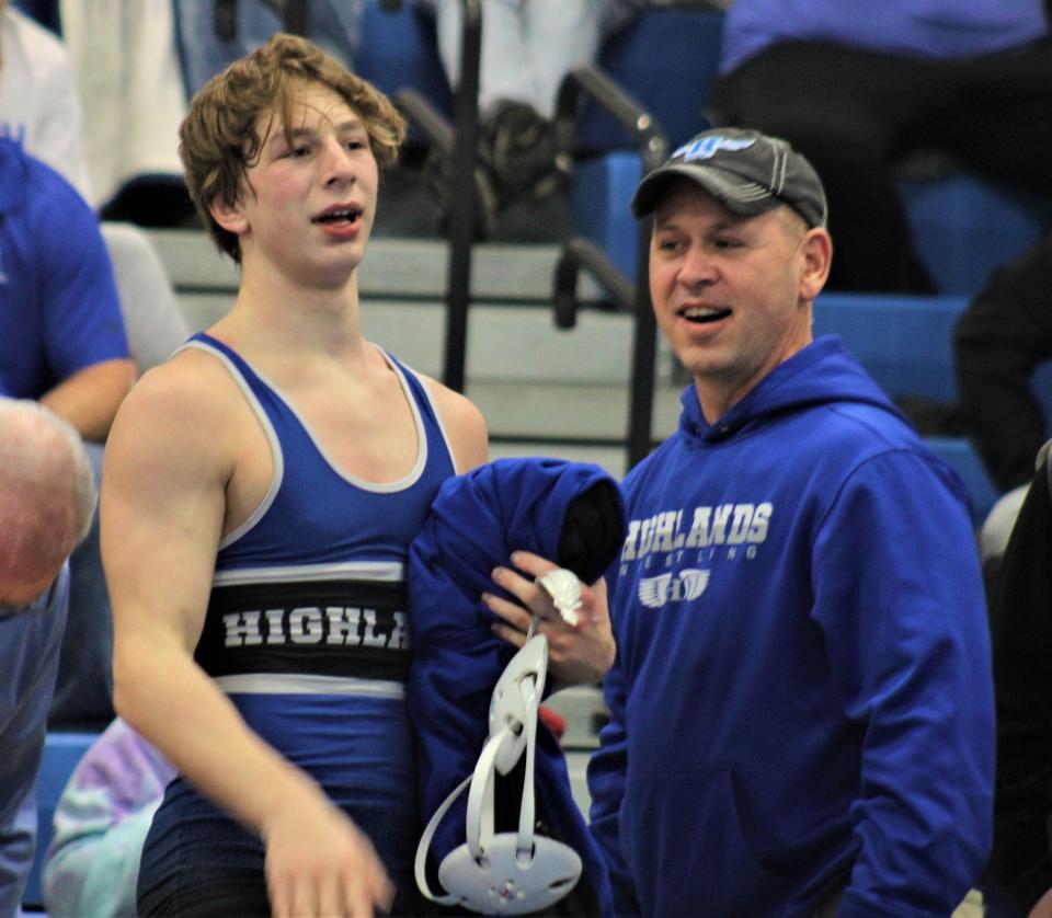 Rilen Pinkston with his father after winning Highlands' first ever regional wrestling title.