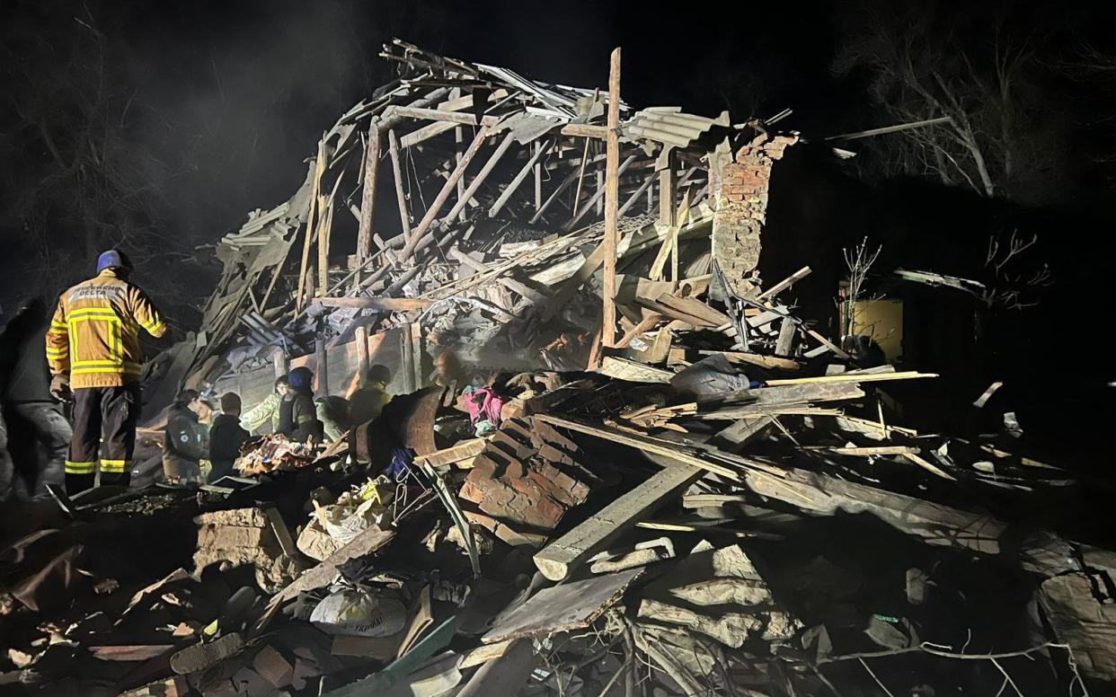 Rescuers at work on the rubbles of a house destroyed as a result of a Russian missile strike in Kostyantynivka - HANDOUT/AFP