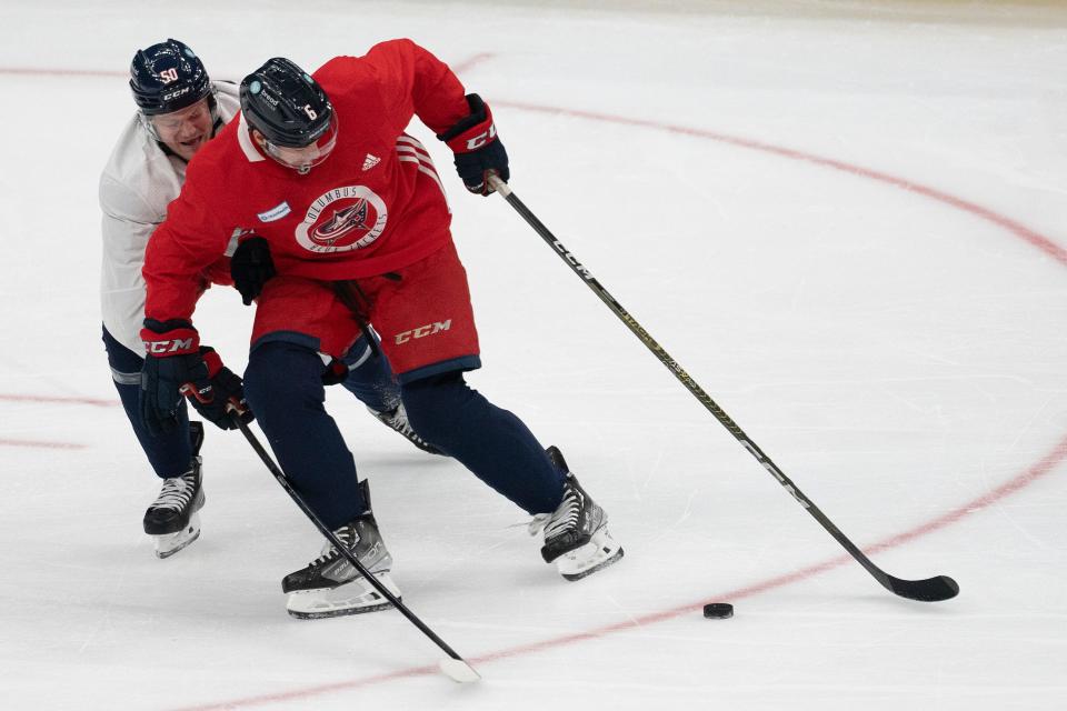 Sep 29, 2023; Columbus, Ohio, United States; Columbus Blue Jackets defenseman Billy Sweezey (6) and Columbus Blue Jackets left wing Eric Robinson (50) fight for the puck during CBJ Training Camp at Nationwide Arena.