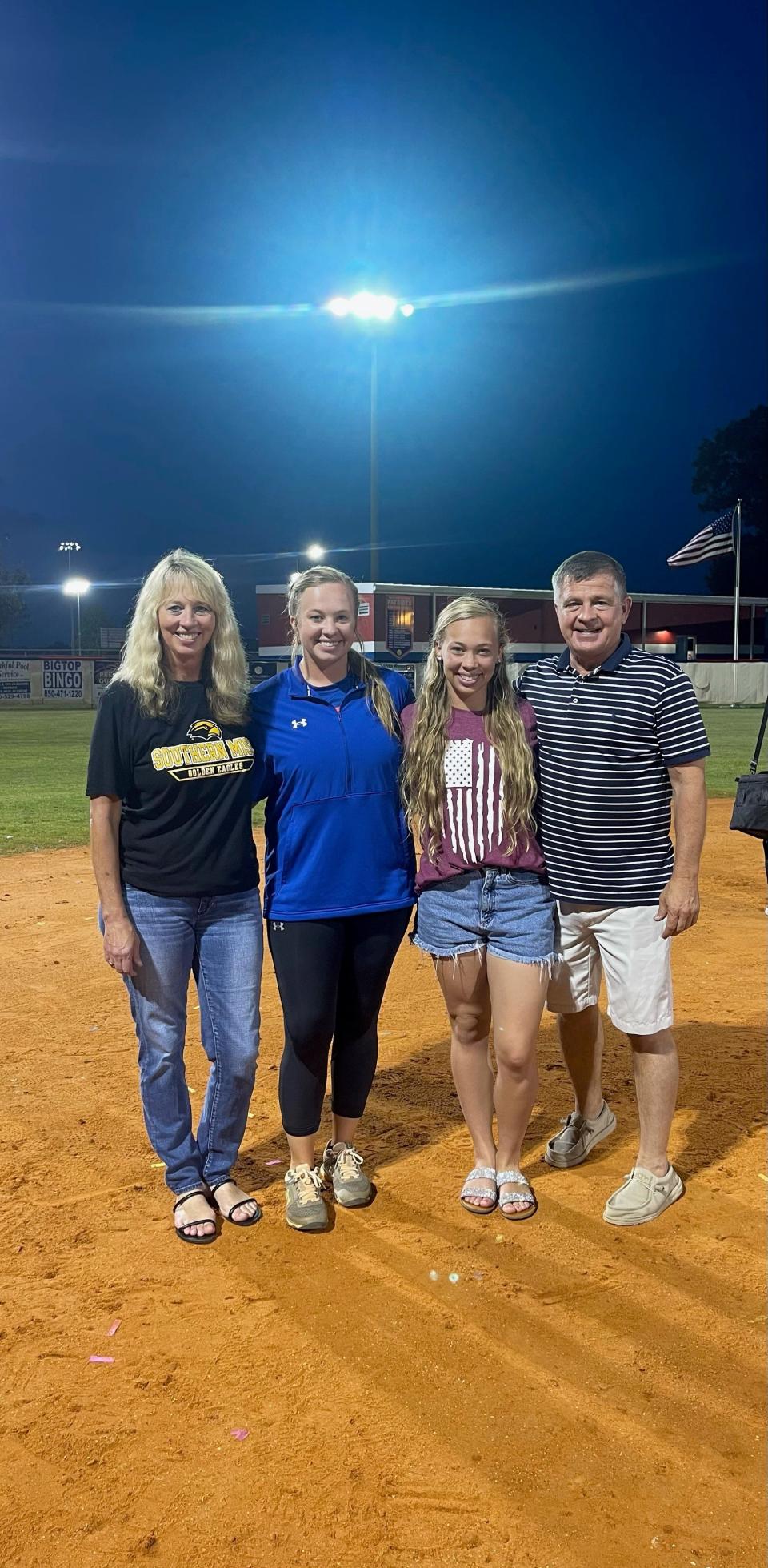 New Pace softball head coach Lexi Worrell (center left) is joined by her mother Tracey (left), her sister Caroline (center right) and father Danny following a game from an unknown date at Pace High School