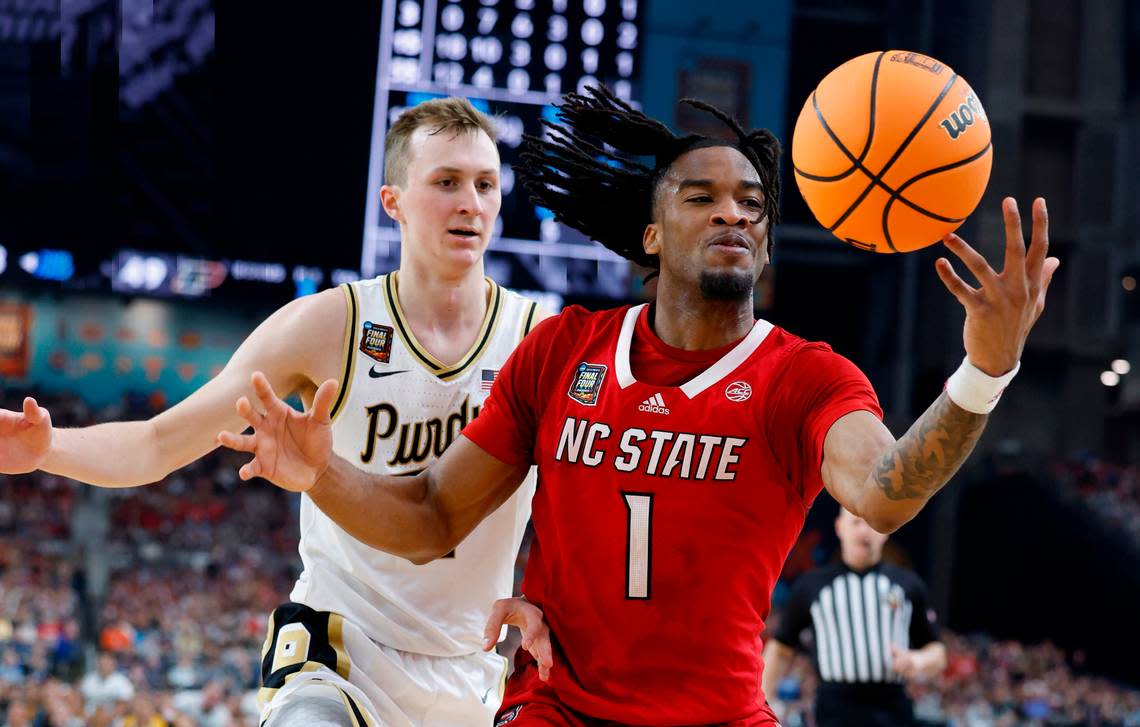 NC State’s Jayden Taylor (1) tries to get possession of the ball as Purdue’s Fletcher Loyer defends in second half action of their Final Four game, Saturday, April 6, 2024. Ethan Hyman/ehyman@newsobserver.com