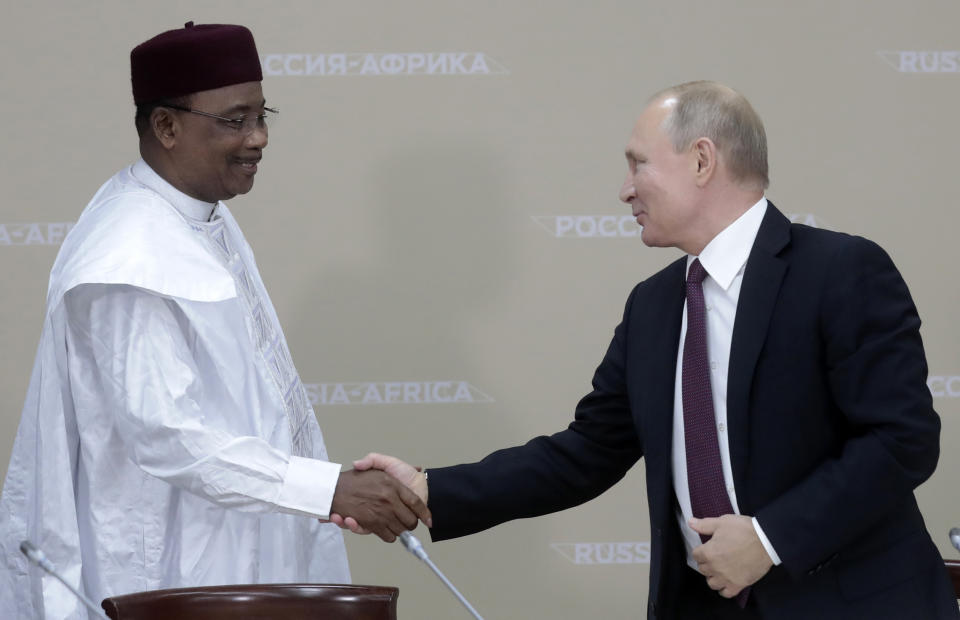Russian President Vladimir Putin, right, shakes hands with Nigerien President Mahamadou Issoufou, after a luncheon with the heads of African regional organizations on the sideline of Russia-Africa summit in the Black Sea resort of Sochi, Russia, Wednesday, Oct. 23, 2019. (AP Photo/Sergei Chirikov, pool photo via AP)