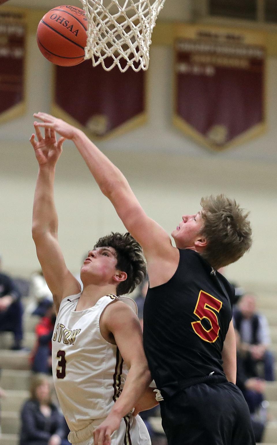 Stow's Luke Abernathy, left, attempts a layup under Brecksville's Matt Rose during the first half of a basketball game on Tuesday in Stow.