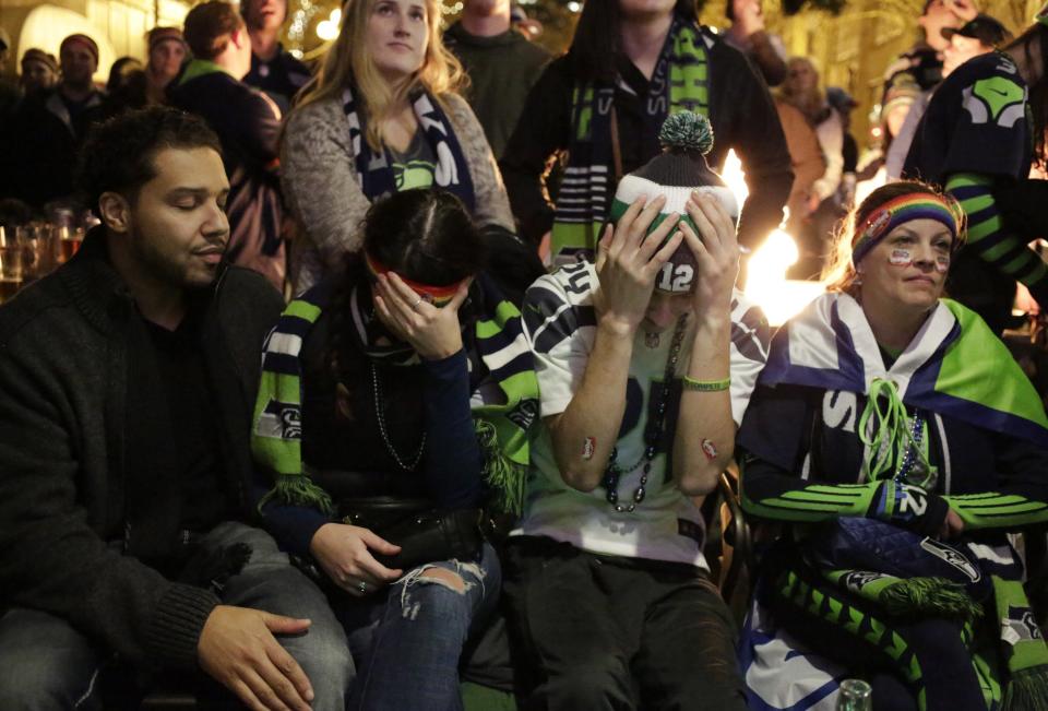 Seattle Seahawks fans react after their team lost the Super Bowl XLIX to the New England Patriots, in Seattle, Washington February 1, 2015. The New England Patriots beat the Seahawks 28-24 to win the NFL championship, Sunday in Glendale, Arizona. REUTERS/Jason Redmond (UNITED STATES - Tags: SPORT FOOTBALL)