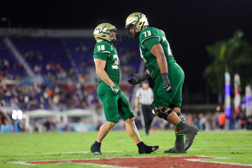 Dec 21, 2023; Boca Raton, FL, USA; South Florida Bulls offensive lineman Donovan Jennings (73) congratulates wide receiver Sean Atkins (38) after scoring a touchdown against the Syracuse Orange in the first quarter during the RoofClaim.com Boca Raton Bowl at FAU Stadium. Mandatory Credit: Nathan Ray Seebeck-USA TODAY Sports