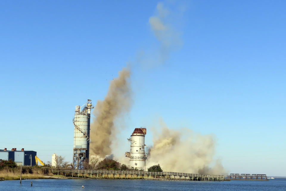 The smokestack at the former B.L. England power plant in Upper Township, N.J., is toppled during a control demolition, Thursday, Oct. 26, 2023. The site will be redeveloped as a mixed use residential and commercial project, and a nearby electrical substation will be used to connect New Jersey's soon-to-come offshore wind farms with the electrical grid. (AP Photo/Wayne Parry)