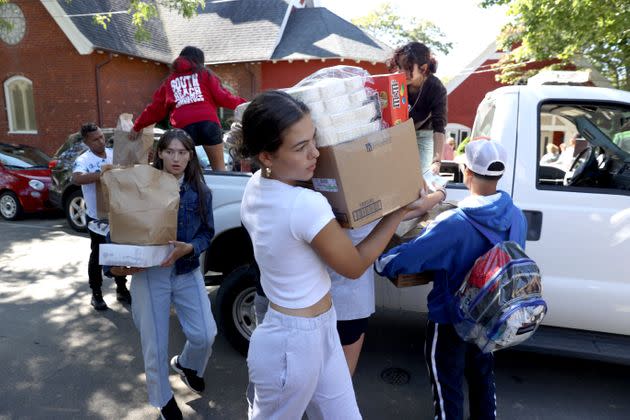 Students from the Marthas Vineyard Regional High School AP Spanish class help deliver food to St. Andrew's Episcopal Church. Two planes of migrants from Venezuela arrived suddenly Wednesday night on Martha's Vineyard. The students served as translators for the migrants. 